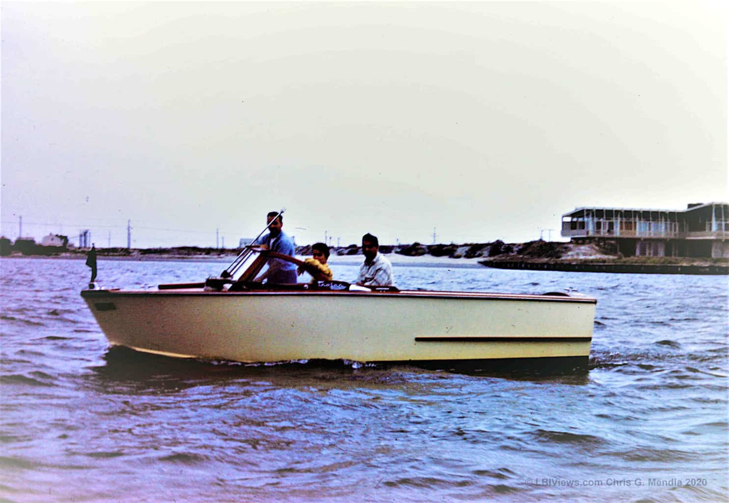 Old wooden inboard runabout in front of the Shapiro Mansion - Long Beach Island - 1950's